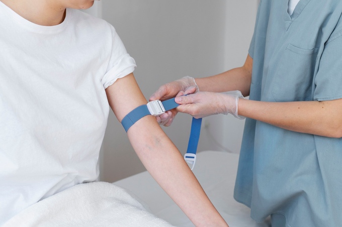 Healthcare professional preparing arm blood