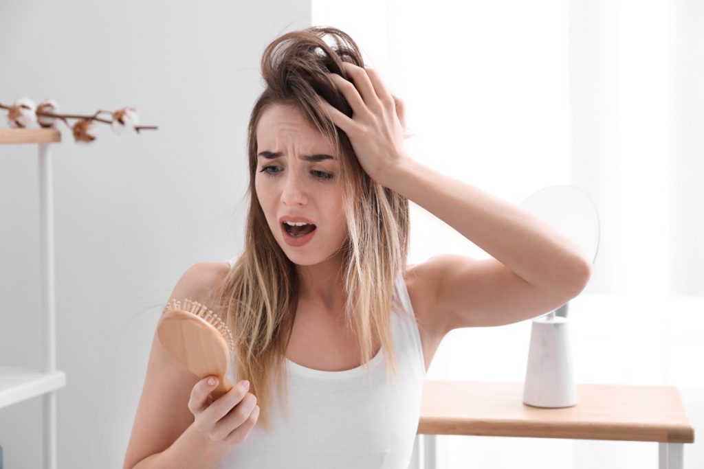 8 Ways To Relieve Postpartum Hair Loss, According to a Hair Loss Doctor