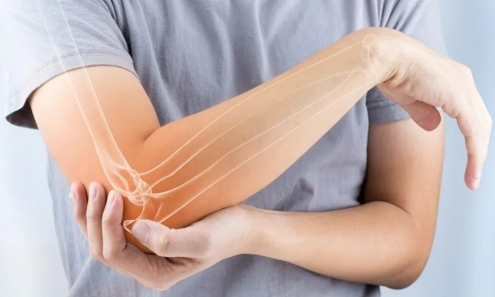 Person experiencing pain from tennis elbow