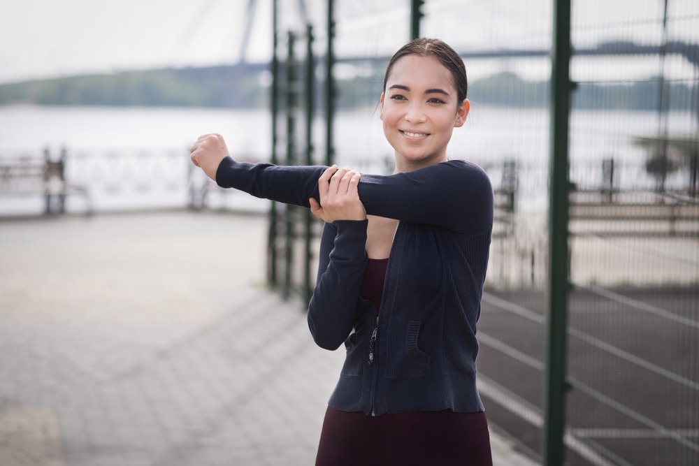 portrait-young-woman-stretching-outdoors-1.jpg