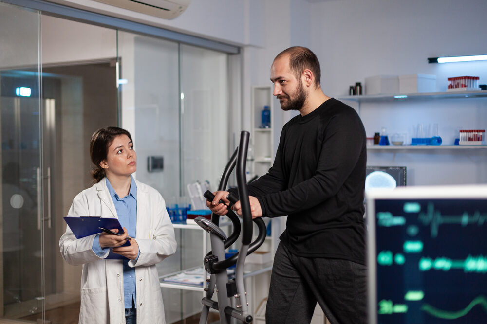 runner-man-sport-equipment-working-body-endurance-medical-examination-modern-laboratory-while-woman-researcher-analyzing-ekg-data-measuring-heart-rate-pulse-medicine-service-1.jpg