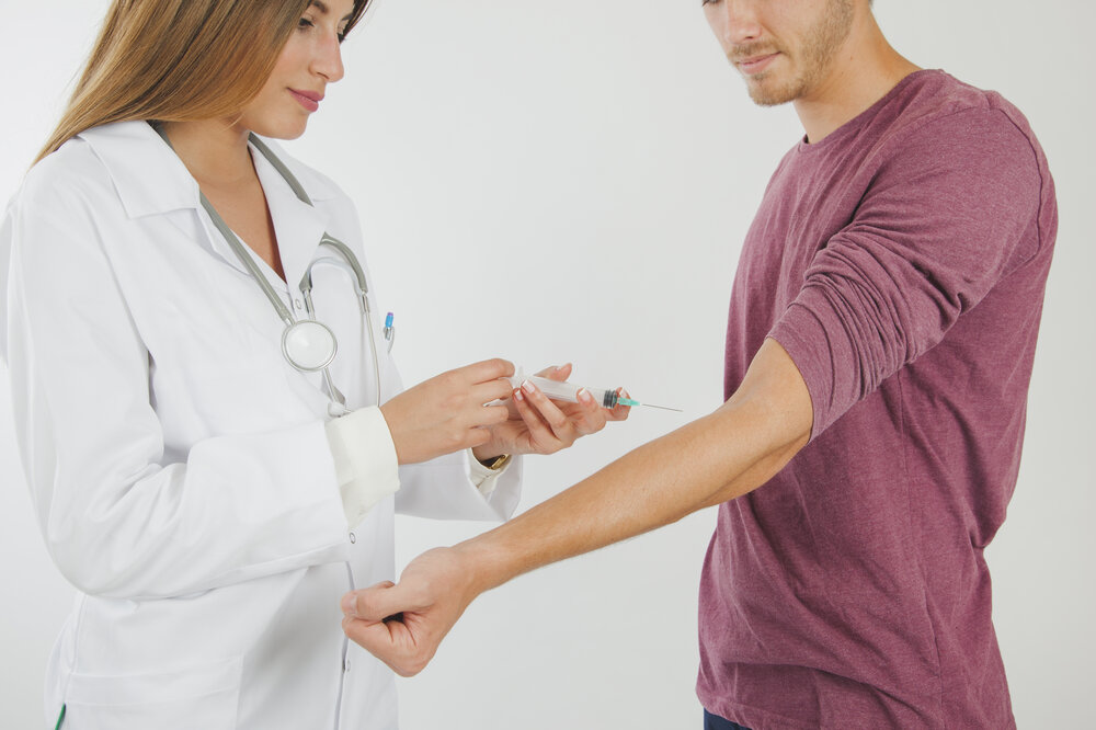 female-doctor-taking-blood-from-patient-1.jpg