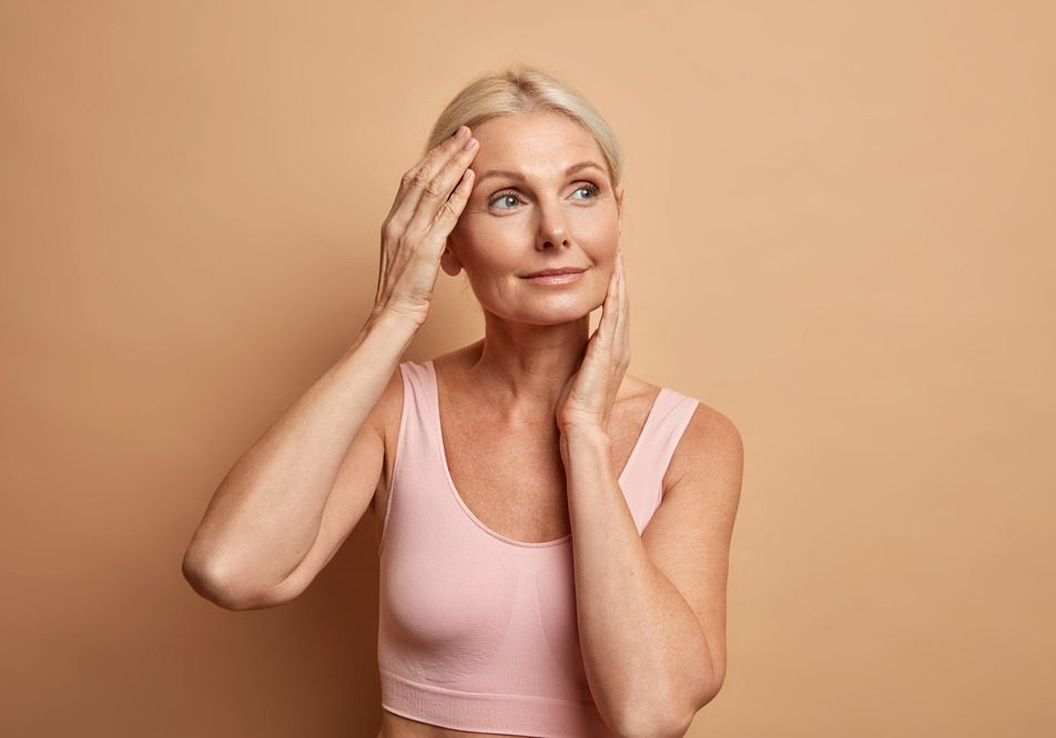 portrait-mature-elderly-european-woman-touches-face-gently-has-perfect-skin-looks-thoughtfully-away-enjoys-her-soft-complexion-cares-about-appearance-satisfied-after-anti-aging-procedure-1.jpg